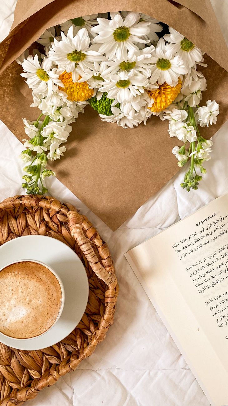 bouquet beside a cup of coffee